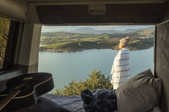 Side view woman admiring nature while road trip