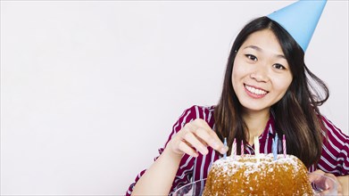 Smiling birthday girl with tasty cake