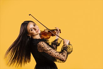 Smiling girl playing violin