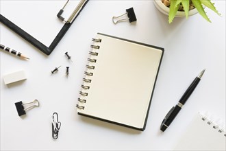 Top view office stationery with notebook pins