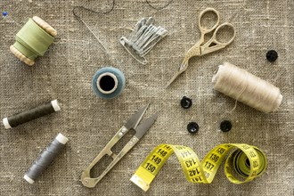 Top view sewing essentials with scissors thread