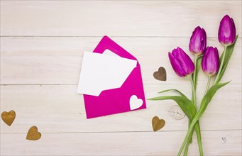 Tulip flowers with blank paper envelope