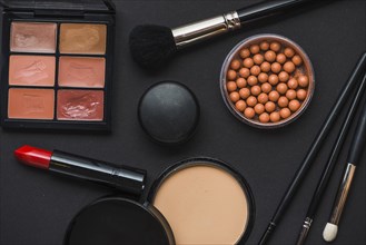 Various makeup products black background