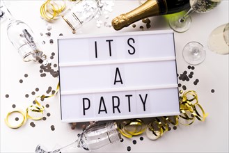 White light box with it s party text champagne bottle white backdrop