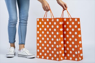 Woman holding shopping bags mock up near legs