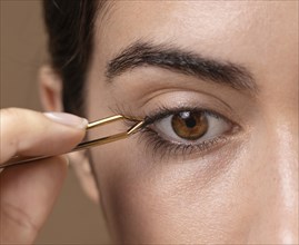 Woman taking care her eyelashes