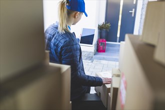 Woman with tablet delivering mail