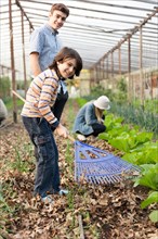 Young gardeners having fun greenhouse