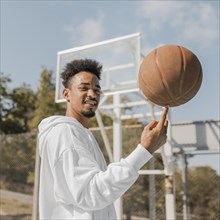 Young man doing tricks with basketball