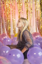 Young pretty girl festive party with balloons
