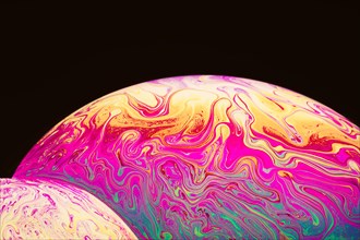 Abstract varicolored psychedelic soap bubbles black background