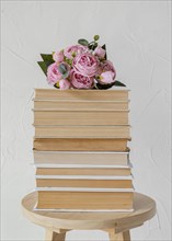 Arrangement with books stack roses