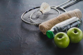 Badminton rackets with apples water bottle