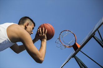 Basketball player throwing ball into net