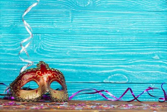 Beautiful carnival mask blue wooden background