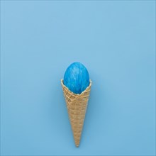 Blue egg waffle cone blue background