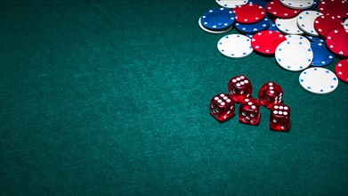 Bright red dices casino chips green poker background