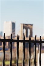 Brooklyn bridge through black fence