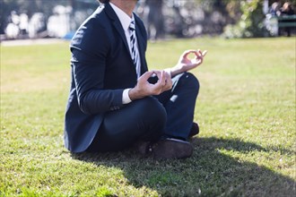 Businessman suit practicing yoga