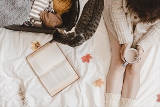 Cat near woman warm clothes bed
