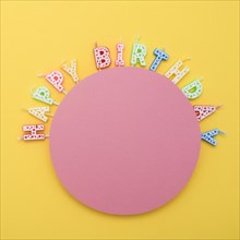 Circle unlit birthday candles with letters
