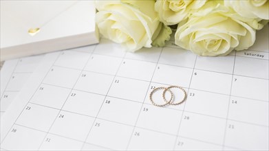 Close up gift box roses wedding rings calendar