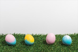 Colorful easter eggs scattered grass