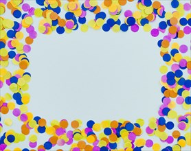 Colourful confetti frame blue background