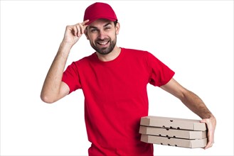 Courier man holding pile pizza boxes his cap