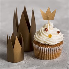 Delicious cupcake with crowns high view