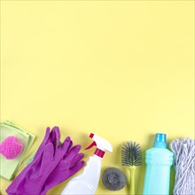 Different cleaning equipments yellow backdrop