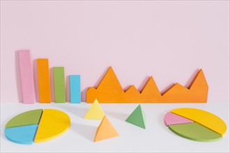 Different colorful graph with pyramid shapes against pink background