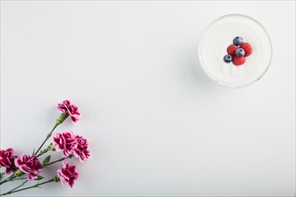 Flowers near yogurt