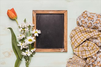 Frame blackboard with flowers shawls
