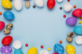 Frame from easter eggs candies blue table