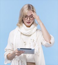 Front view blonde woman holding tablet