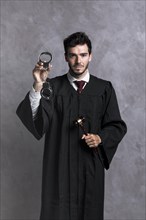 Front view judge robe with handcuffs gavel