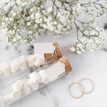 Golden wedding rings baby s breath flowers marshmallow test tubes with white tag