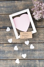 Happy mothers day inscription with flowers paper hearts frame