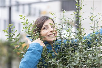 Woman hugging a bush Environmental protection