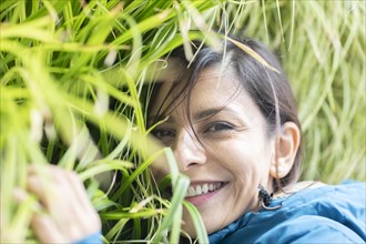 Woman cuddling in a wall of plants Environmental protection
