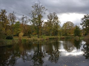 Autumn-coloured trees at the fairytale pond in Glienicker Park
