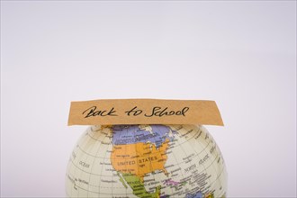 Globe and back to school title on a white background