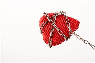 Red color heart shaped object in Chain on white background