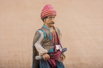 Turkish Ottoman man figurine in view on a brown backgorund