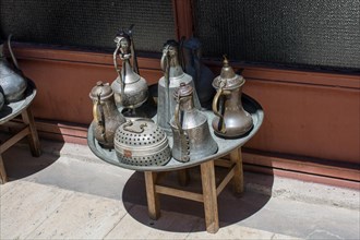 Ancient metal jug in oriental style in antique market