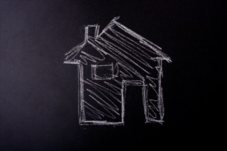 House shape is drawn on a blackboard
