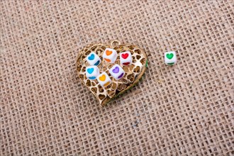 Heart cubes on Heart shaped gold color object