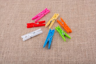 Clothespins placed on a linen canvas background