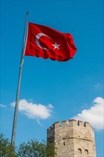 Turkish national flag hang in open air on a tower